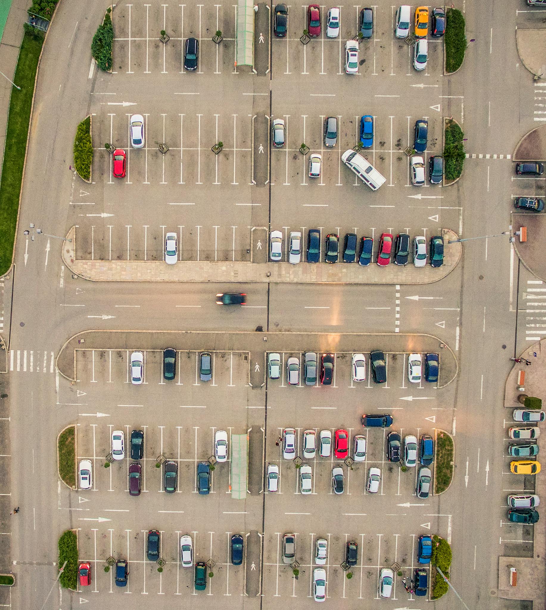 Drone shot of a parking lot with multiple parked cars in Timișoara, Romania.